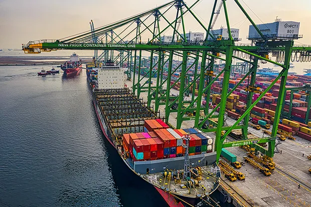 Cargo ship docked at a bustling port